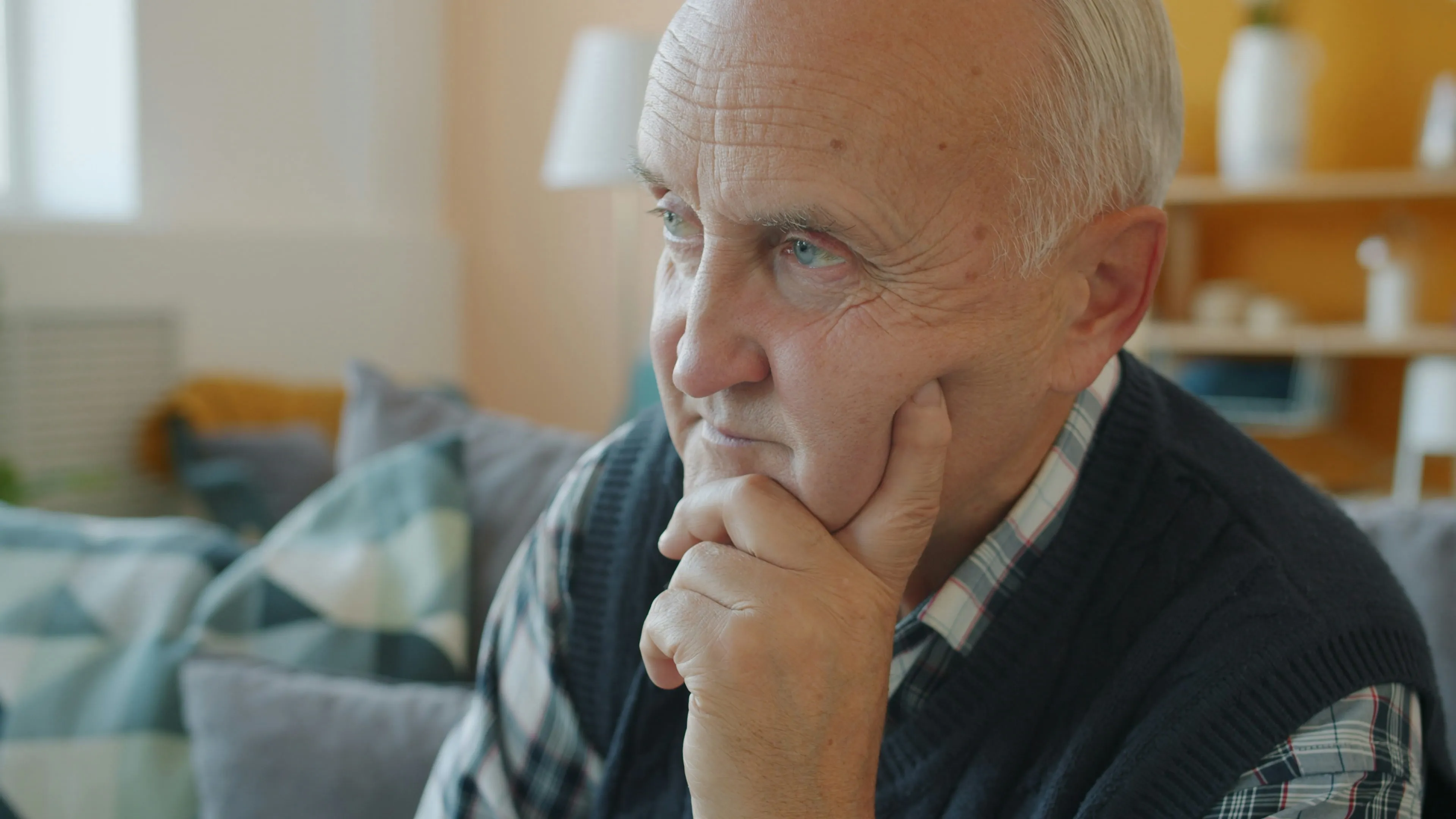 Senior man sitting quietly at home, reflecting